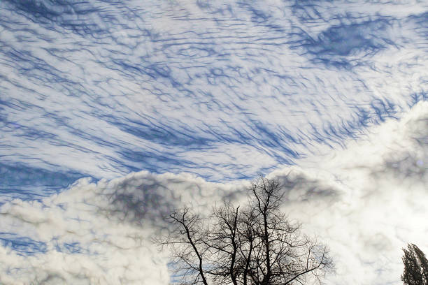 A windy autumn day will often play havoc with the clouds. A high jetstream above streaks out the high cirrus cloud into marestails, while darker cumulus looms below, creating a dramatic combination.