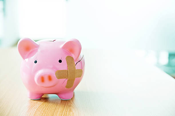 istock Broken piggy bank with band aids 623515998