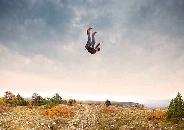 istock man falling down from the sky in autumnal landscape 623518340