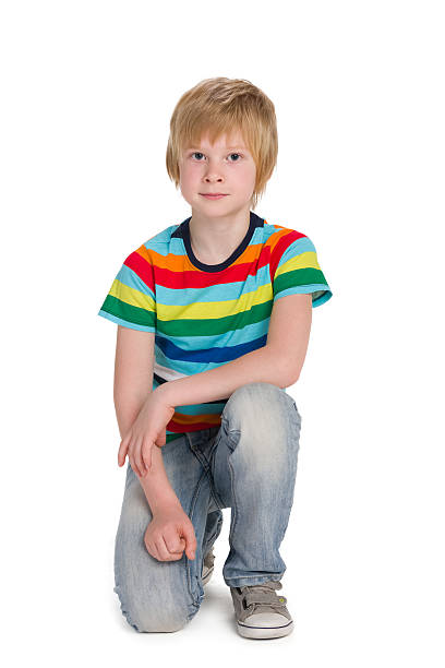 istock Cute boy in a striped shirt sits 623518494
