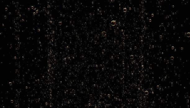 Golden Colored Sparkling Champagne Bubbles on Black Background