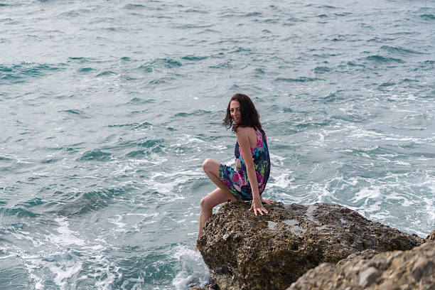 istock Young woman sitting   at the beach 623519192