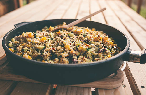 autumnal quinoa salad with pumpkin and vegetables in frying pan - quinoa spoon wood photography imagens e fotografias de stock
