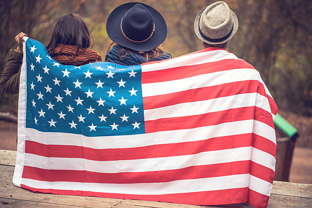 istock Sitting wrapped in usa flag 623520944