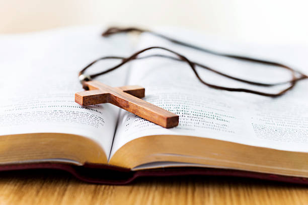 istock Bible and cross on desk 623522798