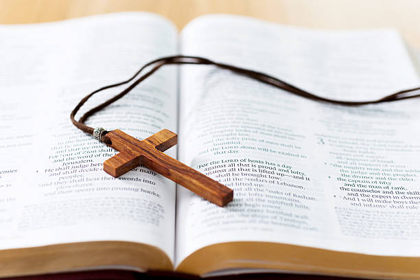 istock Bible and cross on desk 623522950