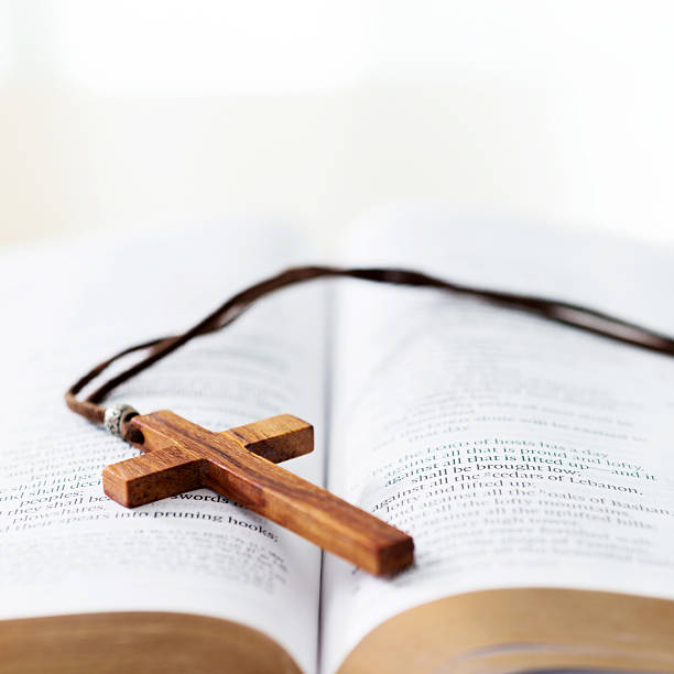 istock Bible and cross on desk 623523002