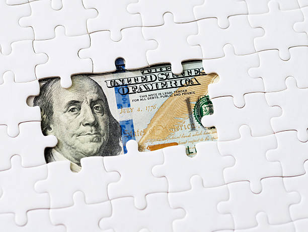 istock US paper currency with jigsaw puzzle 623524508