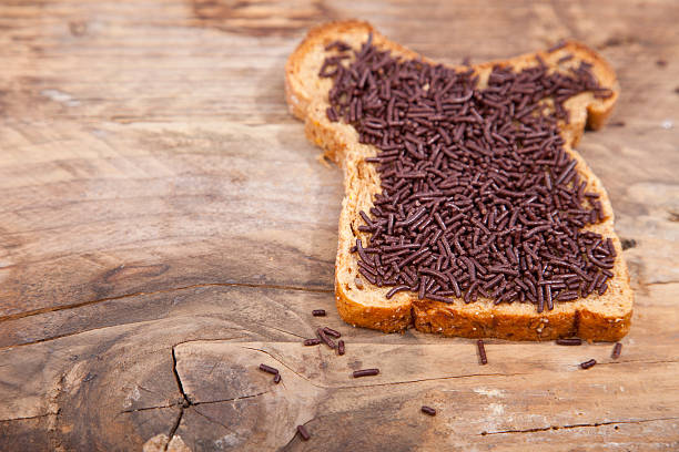 istock Typical Dutch bread with chocolate hagelslag on wooden background 623525312
