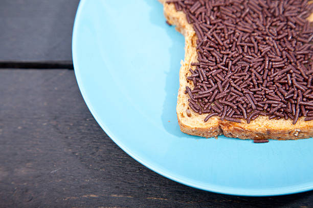 istock Typical Dutch bread with chocolate hagelslag on wooden background 623525418