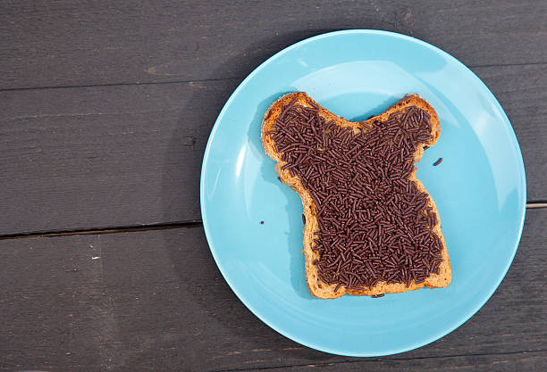 istock Typical Dutch bread with chocolate hagelslag on wooden background 623525474