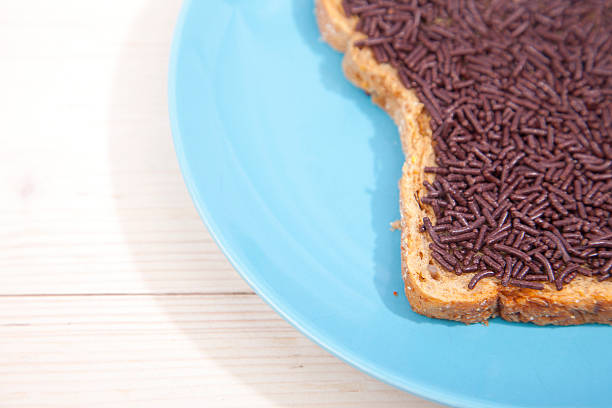 istock Typical Dutch bread with chocolate hagelslag on wooden background 623525580