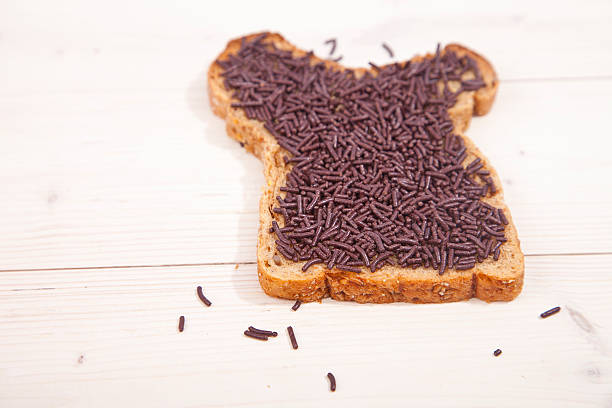 istock Typical Dutch bread with chocolate hagelslag on wooden background 623525622