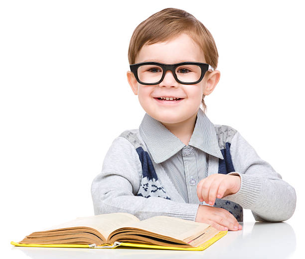 istock Little child play with book 623526742