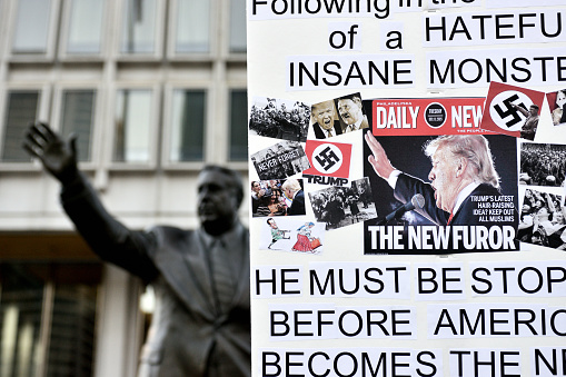 Philadelphia, Pennsylvania, United States - November 13, 2016: President-Elect Trump is compared to Hitler on a sign carried by a demonstrator at a fifth consecutive day of Anti-Trump protests, near the Frank Rizzo statue, in Center City Philadelphia