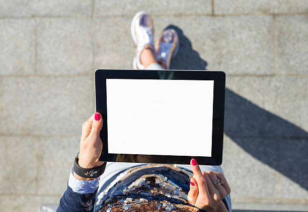 istock woman standing with blank screen tablet 623527942