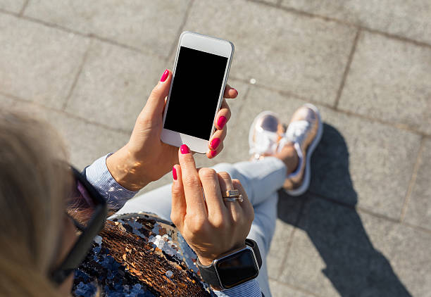 istock woman using smartphone outdoors 623528660