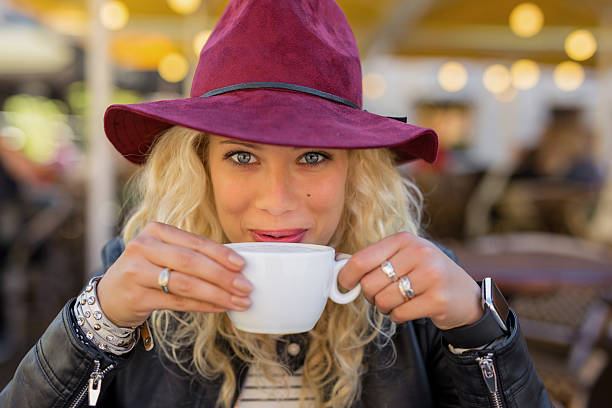 istock beautiful and happy woman drinking coffee from cup 623529524