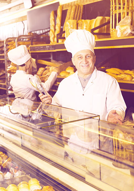 istock Senior man working with sweet confectionery products 623530766