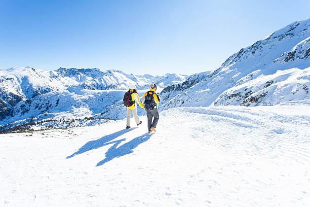 Hikers celebrate the achievement of reaching the top of the mountain in winter