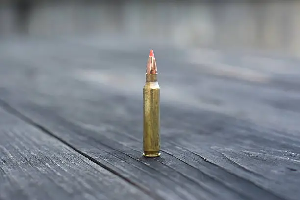 Rifle Ammunition Red Ballistic Tip on wooden Background
