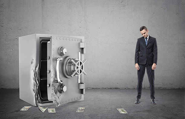 istock Safe with its door broken open and disappointed businessman full 623533736