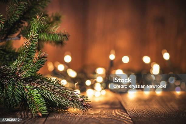 Spruce Tree Branch On Wood Background Stock Photo - Download Image Now - Christmas Lights, Christmas, Christmas Tree