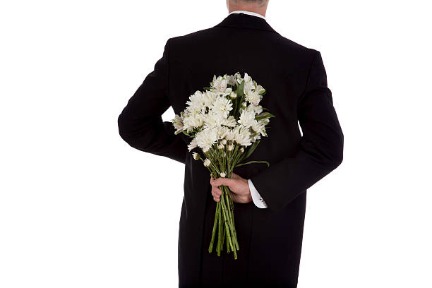 istock Man in tuxedo with flowers 623536114