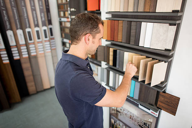 Man at a floor store looking at wood samples