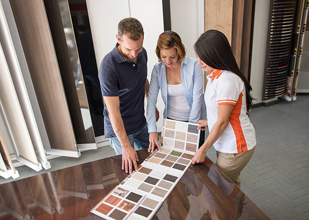 Couple at a floor store looking at wood samples