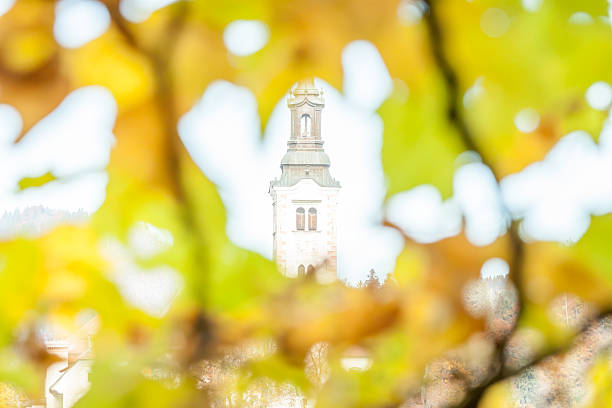 high church through beautiful yellow autumn leaves