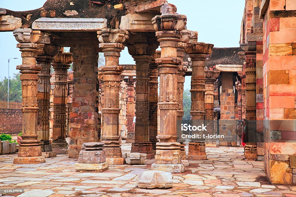 Columns at Quwwat ul-Islam Mosque in Qutab Complex, India Particular of the beautiful columns in the Qutab Minar ruins in Delhi - India Ancient Stock Photo