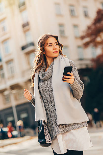 istock Young woman texting outdoors 623538368