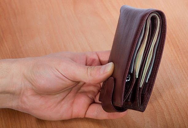 istock purse with money in hand 623539098