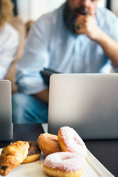 istock Close-up of pastry on table with laptop 623584710