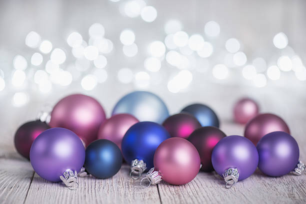 istock Multicolor Baubles on White Rustic Plank and Defocused Christmas Lights 623585430