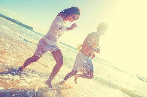 istock Smiling young people running on the beach 623587540