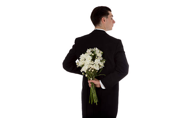 istock Man in tuxedo with flowers 623588036