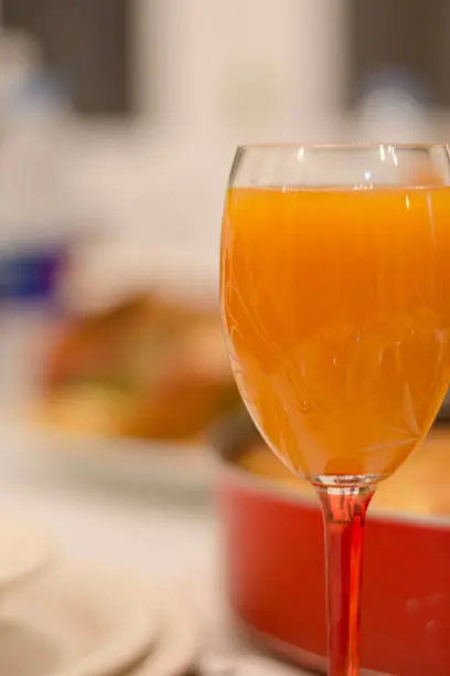 Photo of Orange juice in a glass with bokeh background.