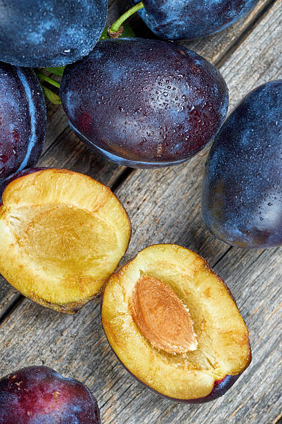 istock Fresh plums on a wooden table 623591536