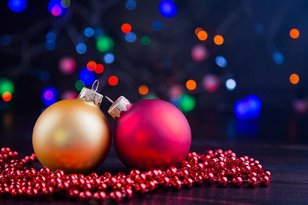 istock Two Christmas balls and beads with garland lights 623592198