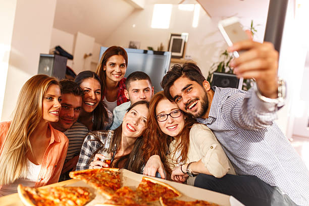 istock Group of young friends eating pizza 623596464