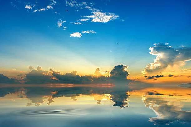 istock beach mirrors the sky at sunrise time 623596856