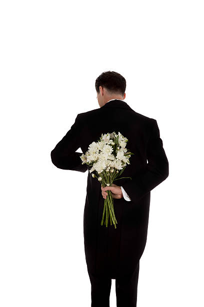 istock Man in tuxedo with flowers 623600592