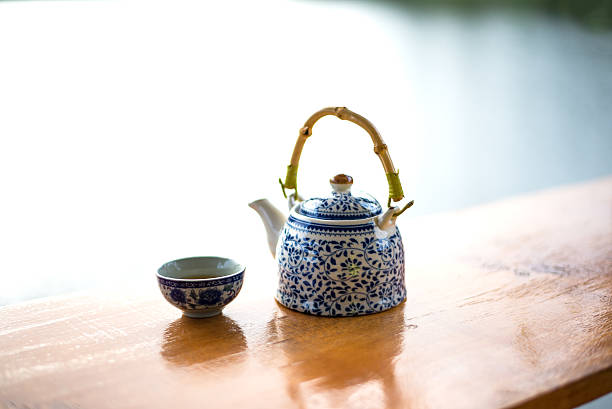 istock Teapot and cups on table in the sunrise 623600910