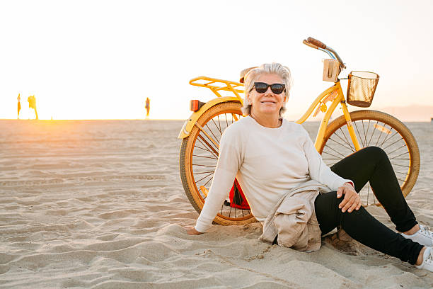 Best way to spend your golden years Lady with a bike 60 69 years stock pictures, royalty-free photos & images