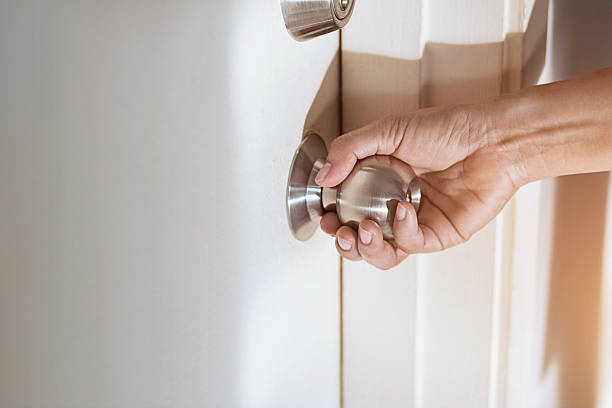 istock woman hand holding a doorknob 623603384