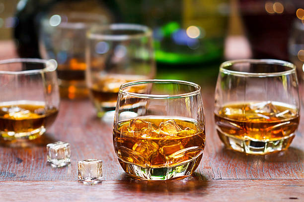 istock whiskey drinks with ice on wooden background 623603440