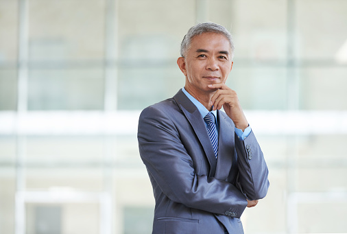 Portrait of happy Taiwan businessman looking at camera