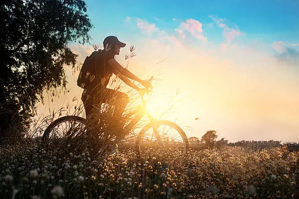 Photo of Biker on mountain bike adventure in beautiful flowers nature